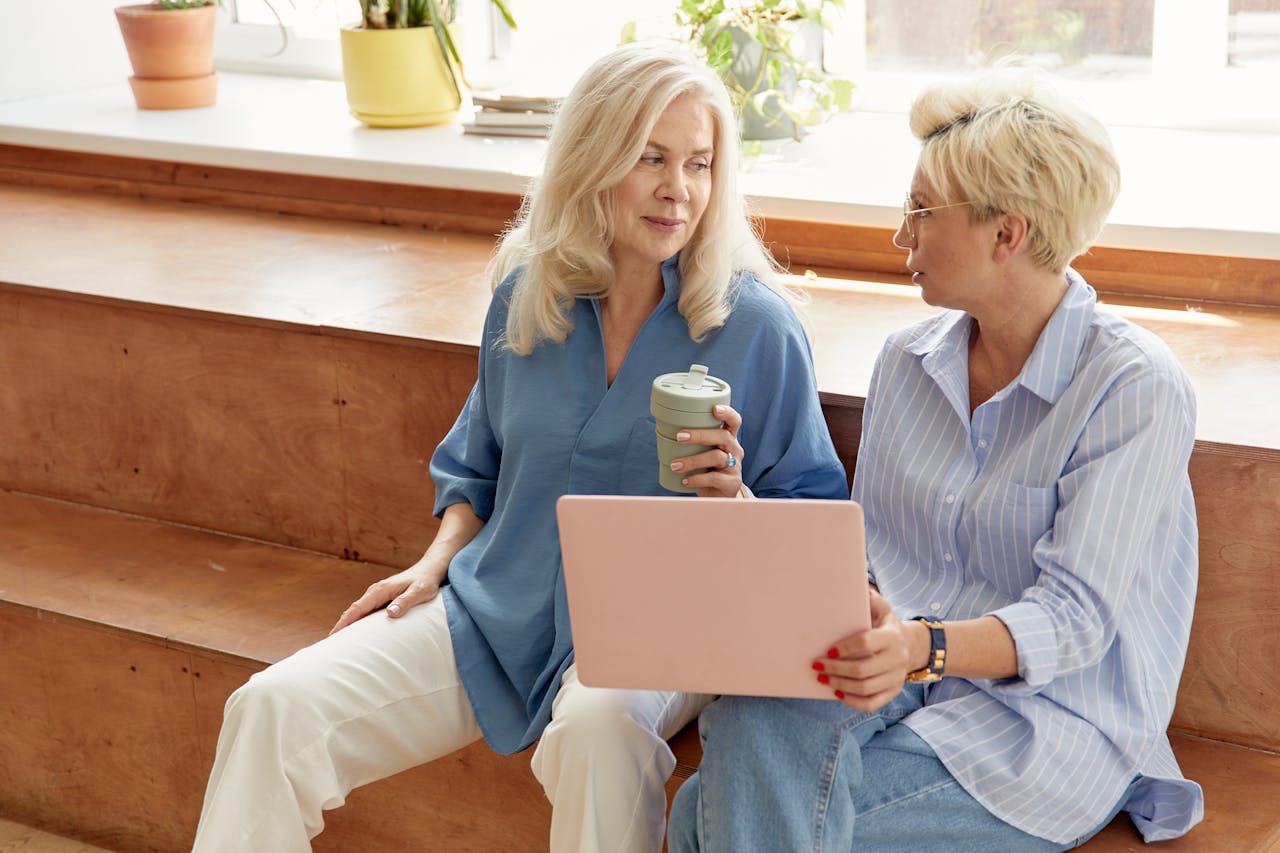 portfolio-02 Two professional women engaging in a business discussion indoors.
